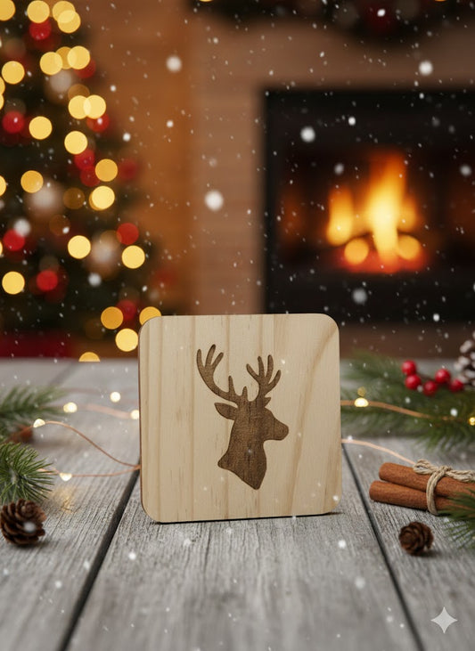 Engraved pine coaster featuring a stag silhouette, displayed in a festive woodland-style scene.